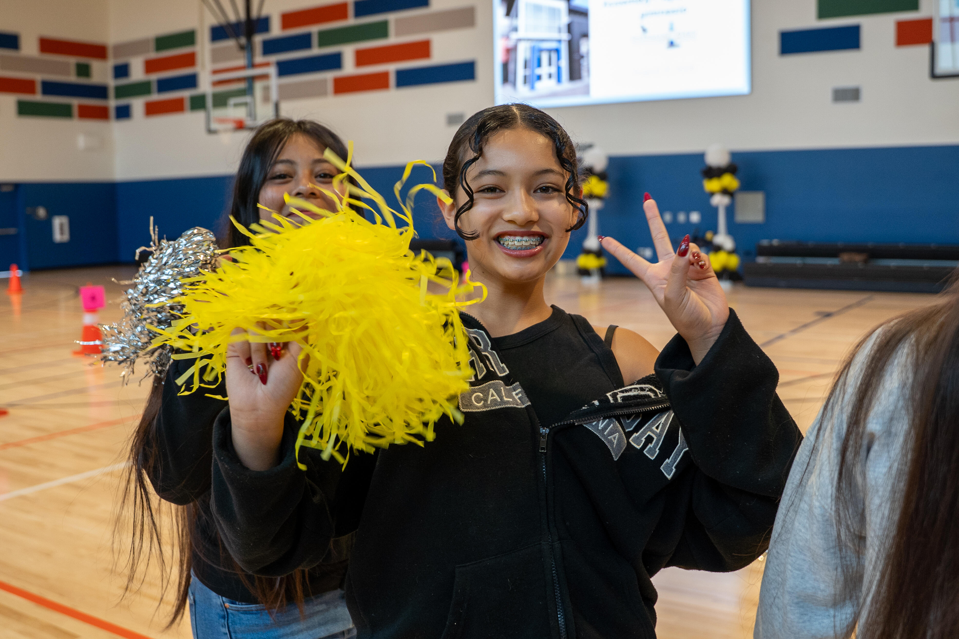 Sherman Oaks student with pompom at the ribbon cutting for the gym.