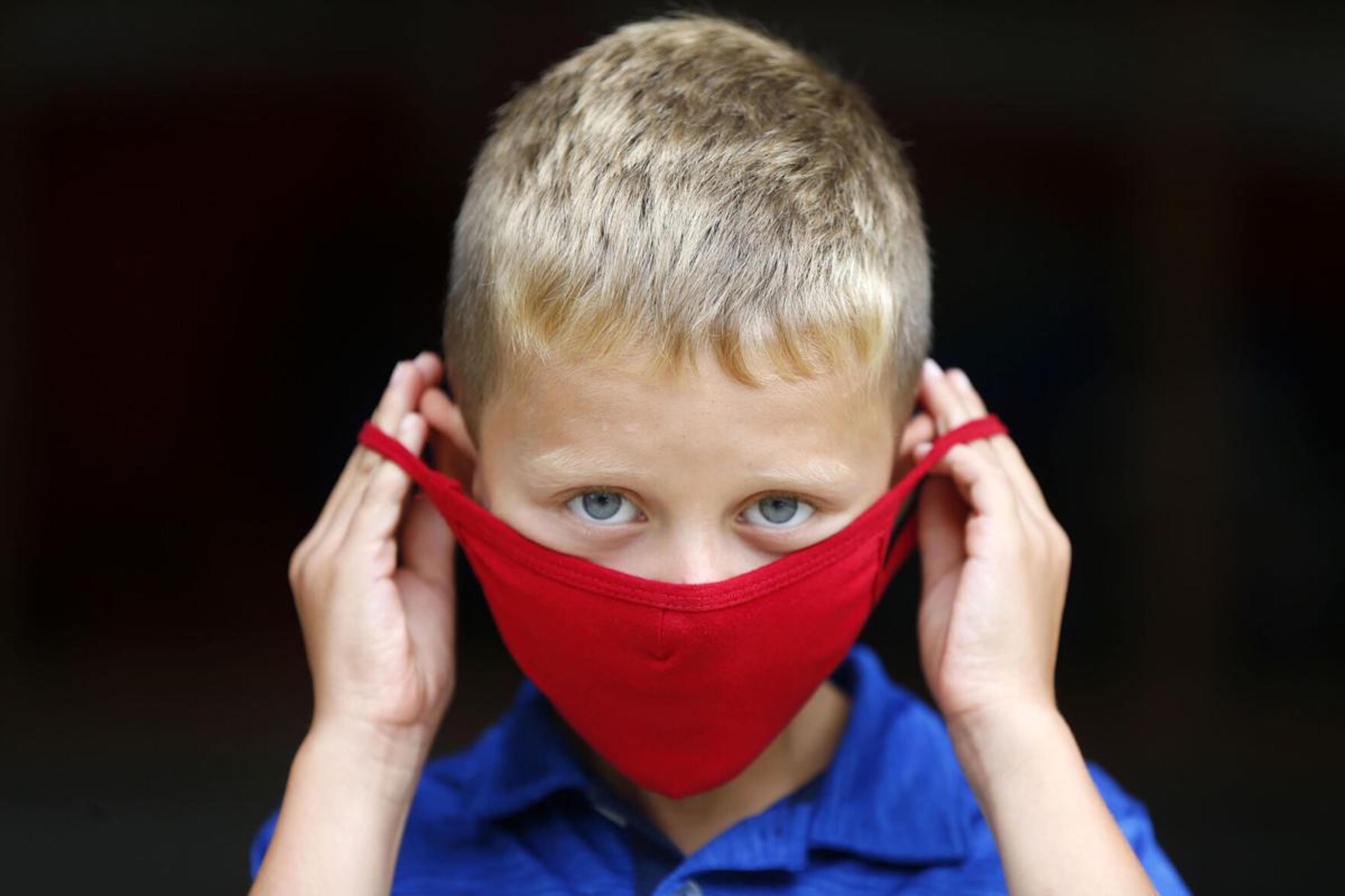 student placing mask on or off