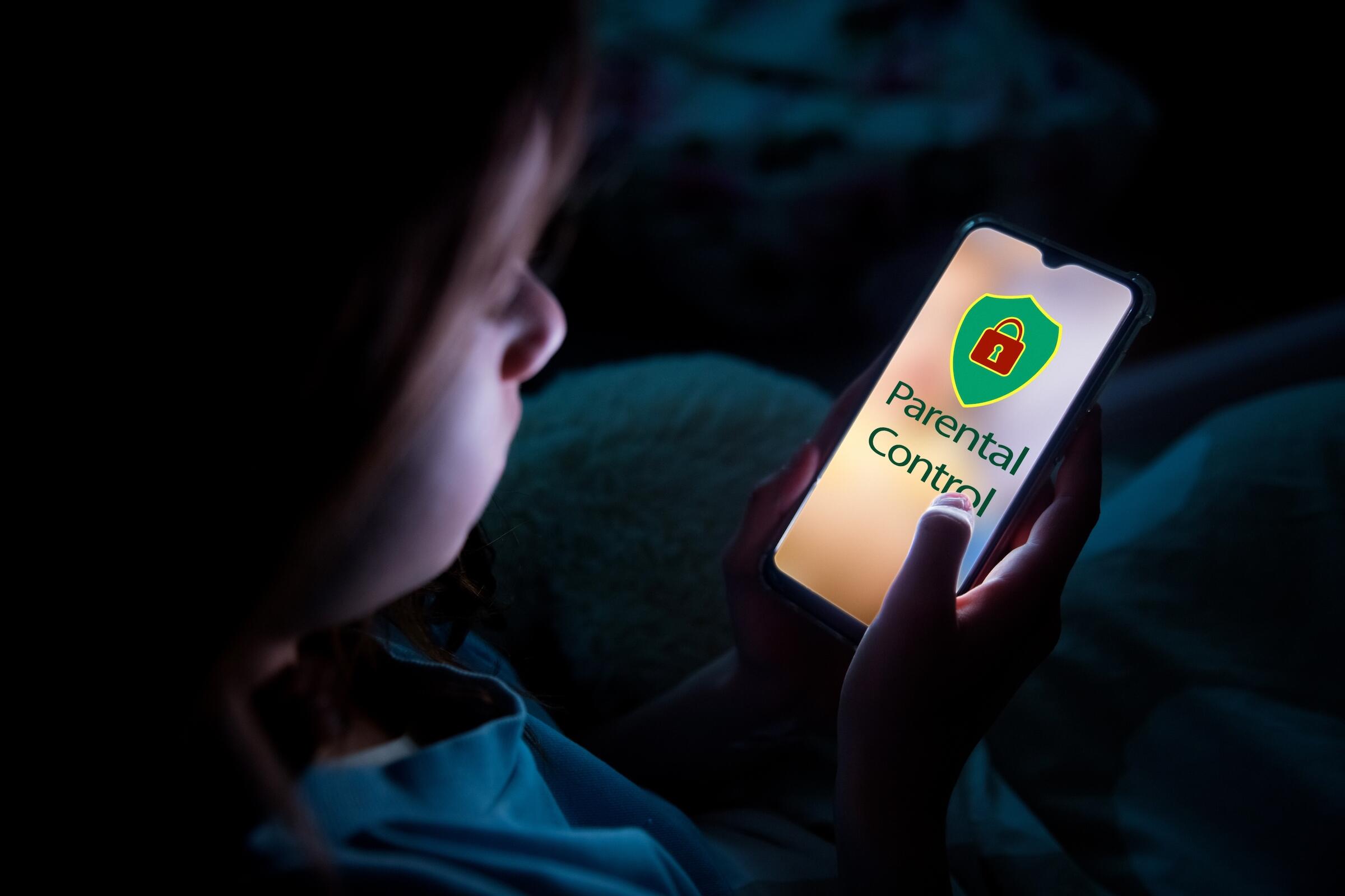 young child looking at cell phone and screen says Parental Control