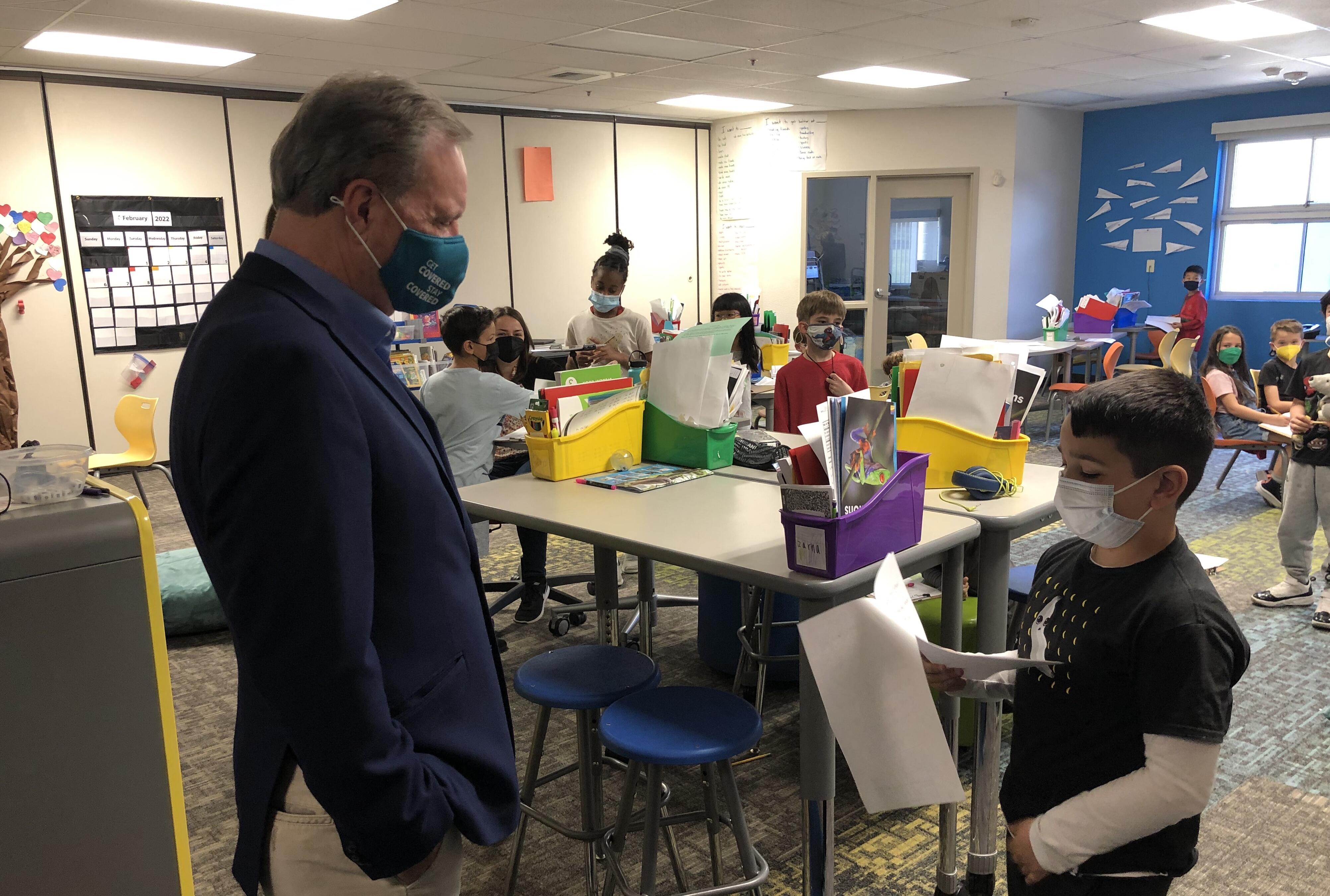 Senator listens as boy reads a letter to him