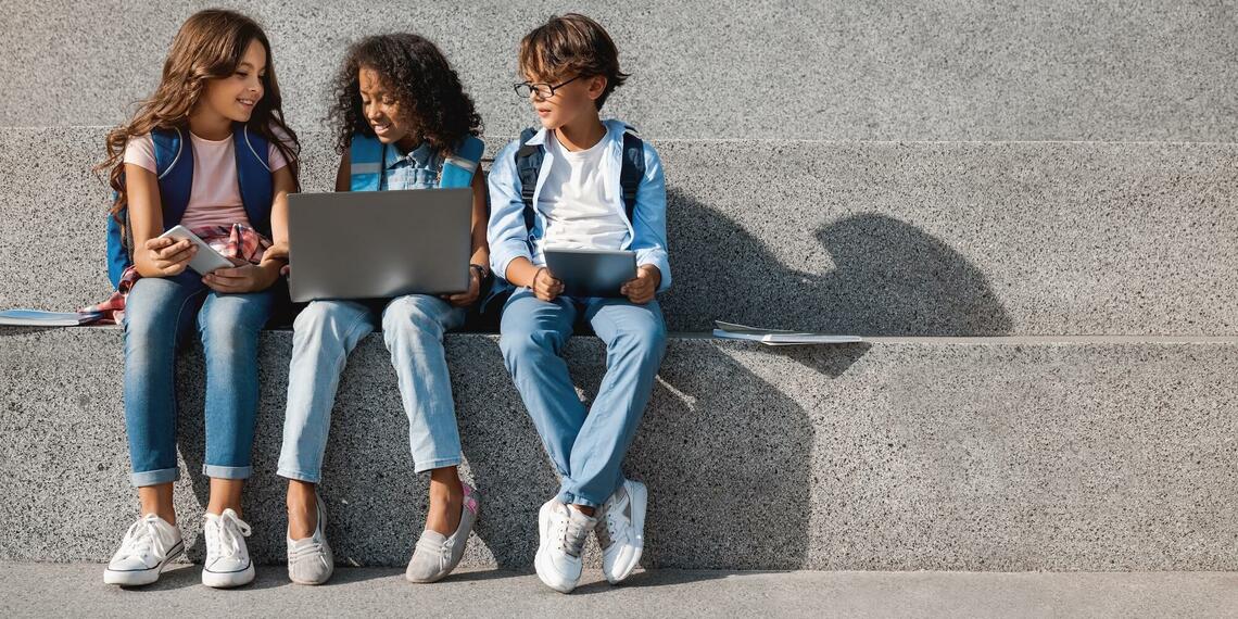 Photo of kids with digital devices