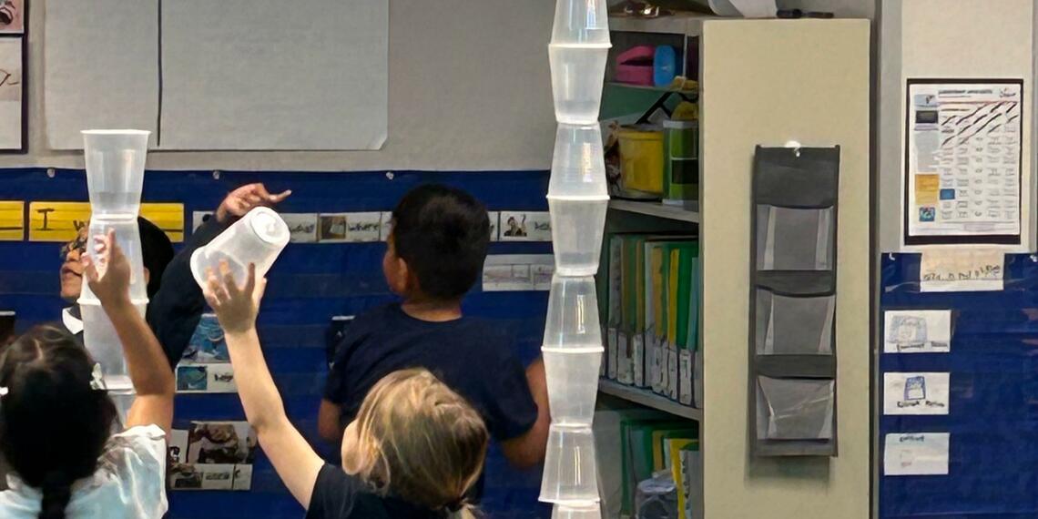 Students building with plastic cups