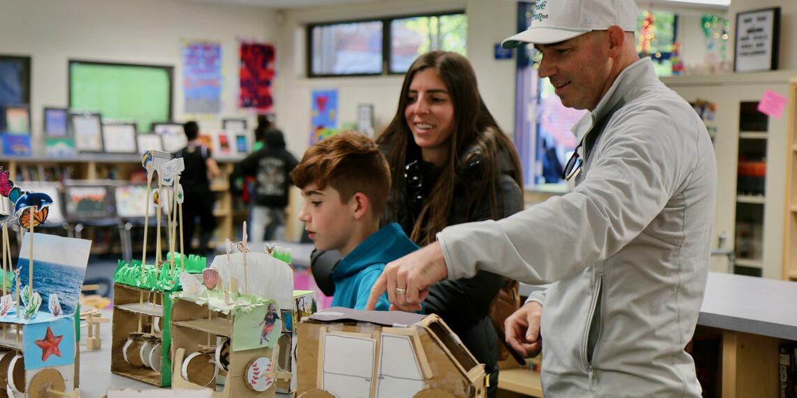 Family exploring projects at last year's AIM Showcase.