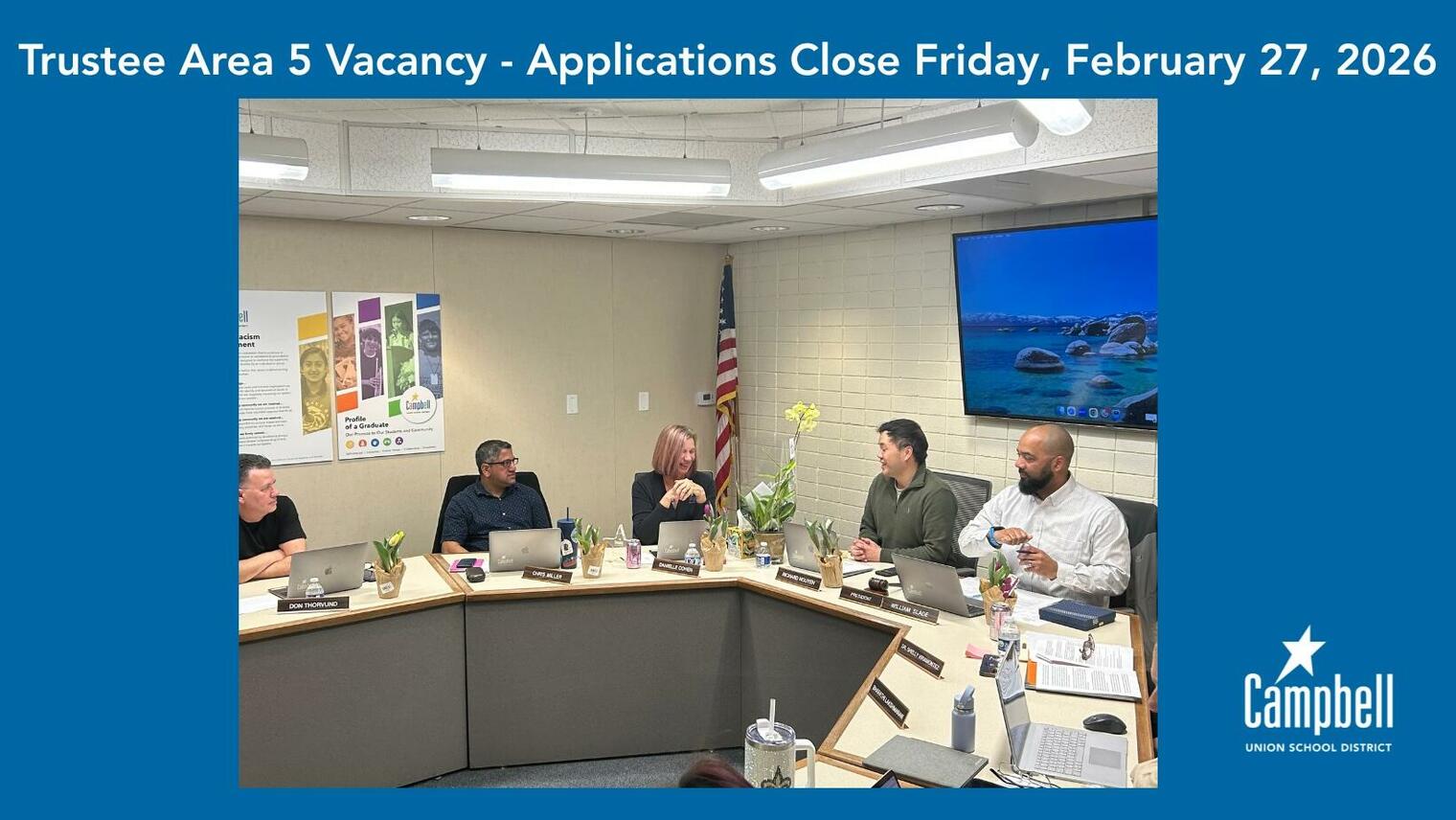 Photo of board members interacting with one another during a board meeting.