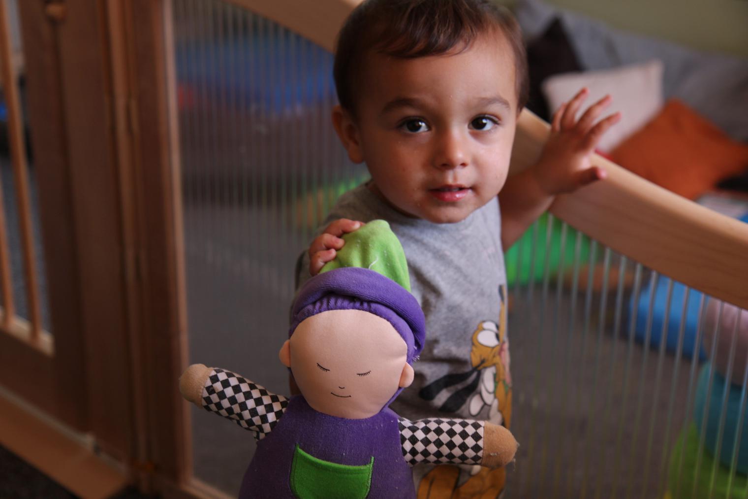 child holding doll