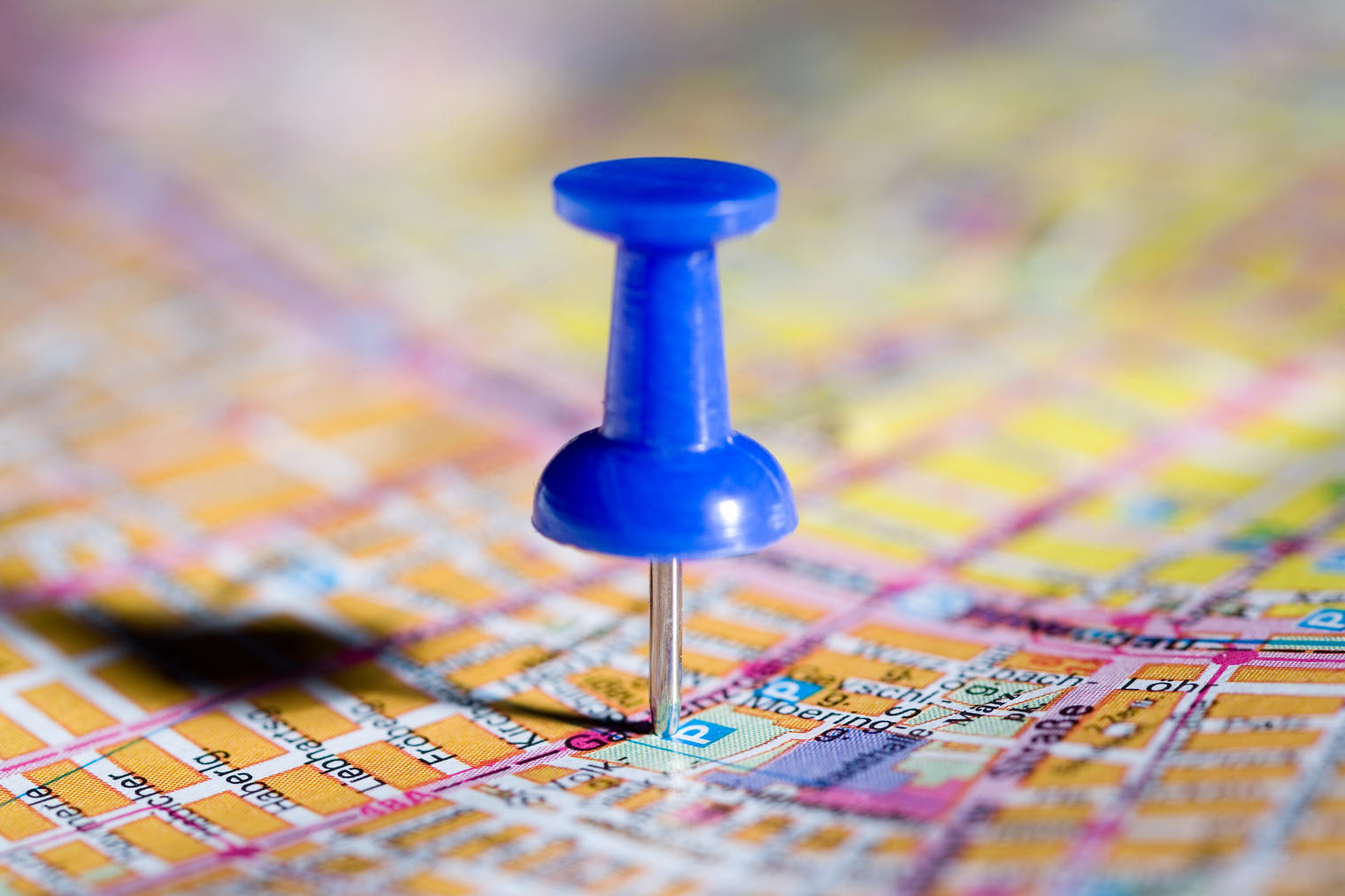 blue pushpin on a map