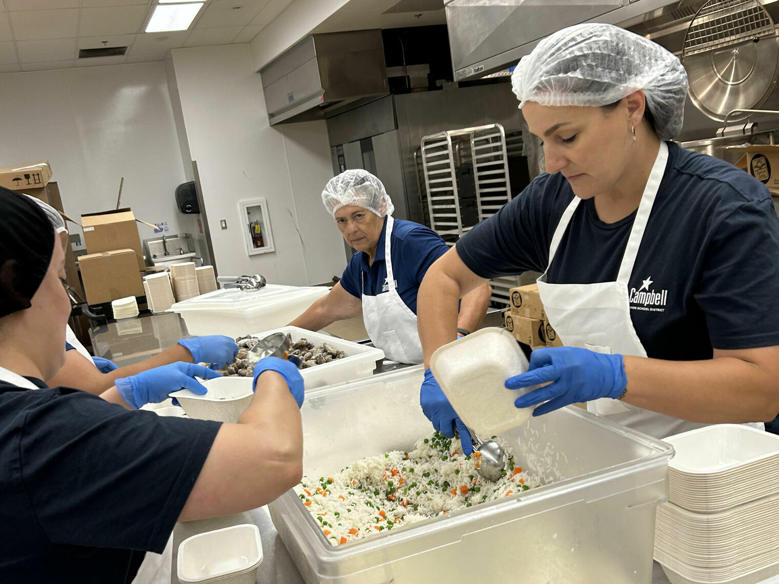 Ladies prepping lunches in the central kitchen.