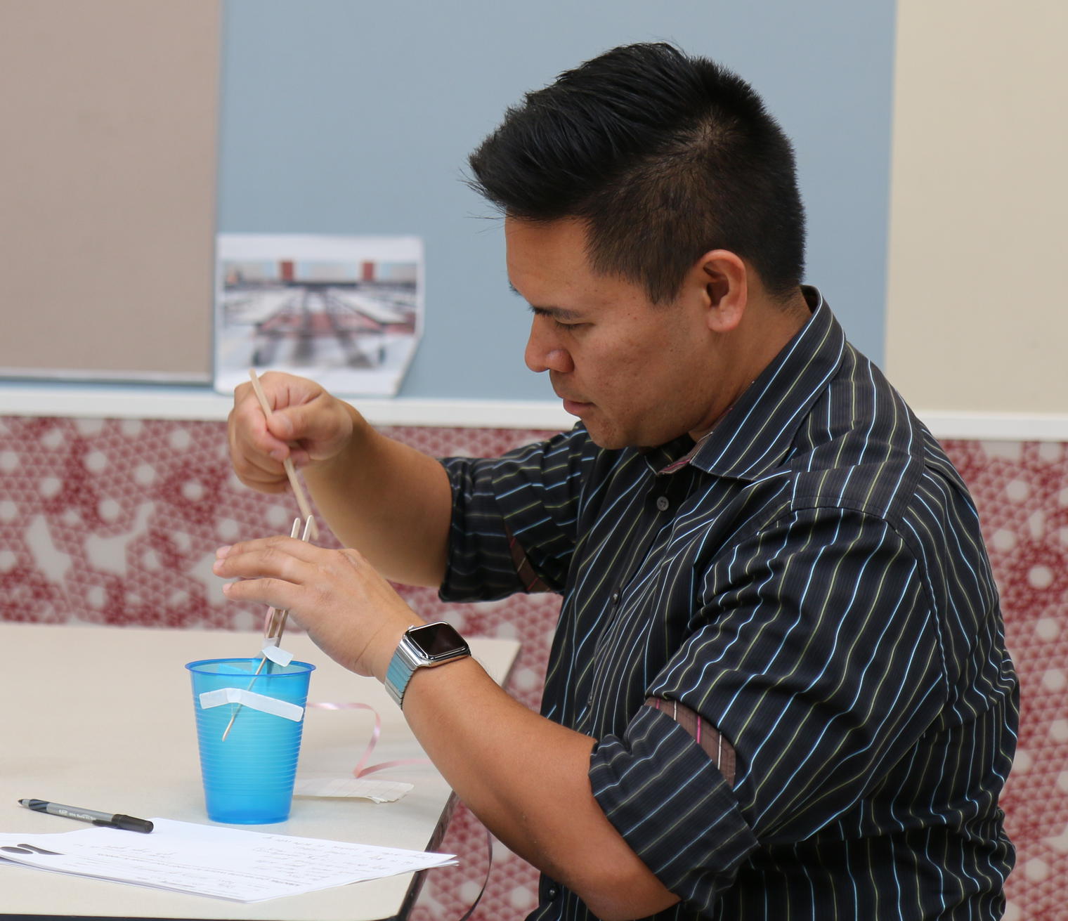 man at table working with tape